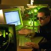 Scientist at a computer in a laser lab
